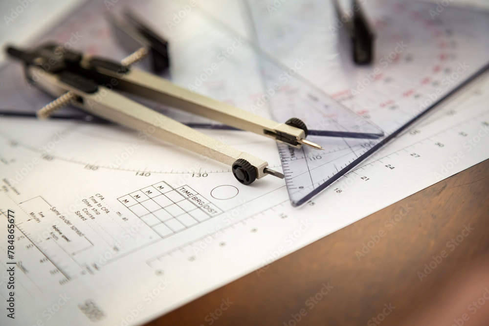 Above image of a navigator's radar plotting chart with a triangler and compass divider Above image of a navigator's radar plotting chart with a triangler and compass divider