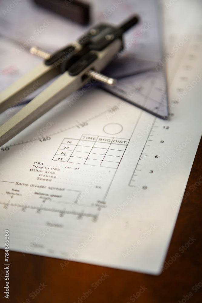 Above image of a navigator's radar plotting chart with a triangler and compass divider Above image of a navigator's radar plotting chart with a triangler and compass divider
