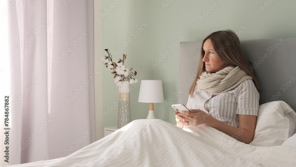 Stricken by illness in bed woman battles disease her phone lifeline. Disease weighs heavy yet she seeks comfort in digital world. With each swipe diseases grip loosens offering brief respite in pixels Stricken by illness in bed woman battles disease her phone lifeline. Disease weighs heavy yet she seeks comfort in digital world. With each swipe diseases grip loosens offering brief respite in pixels