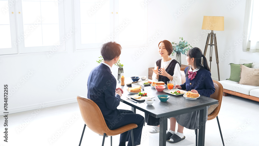 シンプルな部屋で食事する家族