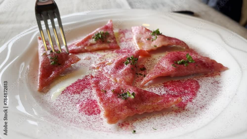 Fork and Beetroot Ravioli on a White Plate in Switzerland Fork and Beetroot Ravioli on a White Plate in Switzerland