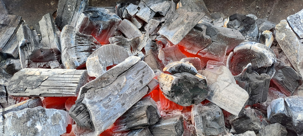 Closeup shot of a pile of charcoal with fire for a barbecue
Closeup shot of a pile of charcoal with fire for a barbecue