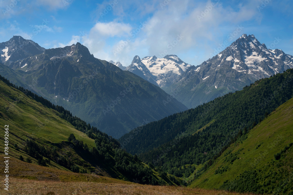 View of the peaks of the North Caucasus mountains near the Arkhyz ski resort on a sunny summer day, Karachay-Cherkessia, Russia