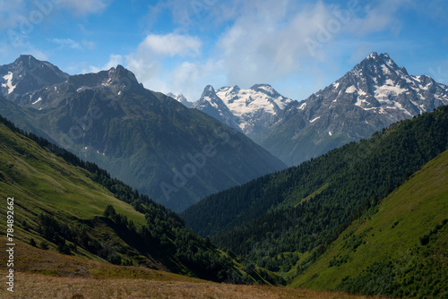 View of the peaks of the North Caucasus mountains near the Arkhyz ski resort on a sunny summer day, Karachay-Cherkessia, Russia