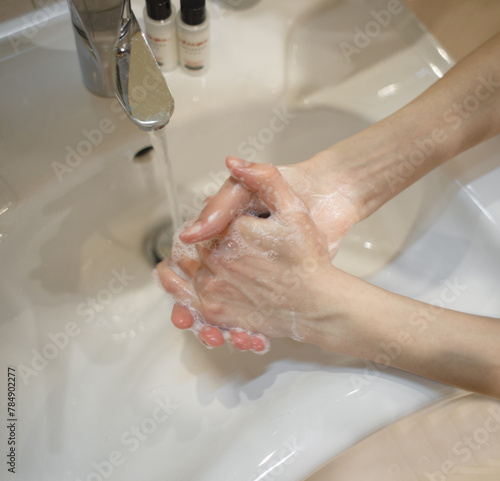 Hands washing with soap, top view.