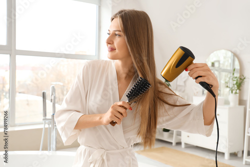 Beautiful young woman dryin...