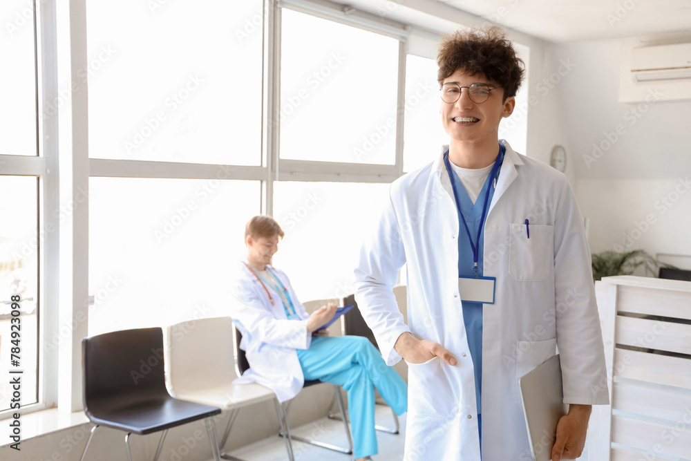 Portrait of male medical intern in clinic