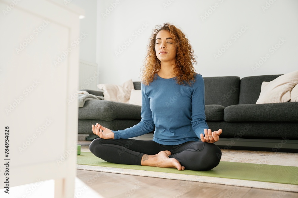 tranquil scene of woman practicing yoga at home