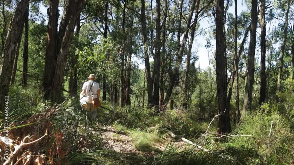 An oldschool historical swagman walking through the Australian bush An oldschool historical swagman walking through the Australian bush