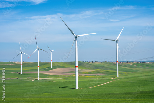 Wind turbines and green meadows seen in Italy