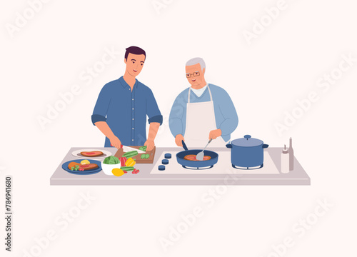 Smiling Elderly Father In Apron Cooking Steak With Frying Pan. Adult Son Helping His Dad To Cut The Cucumber.