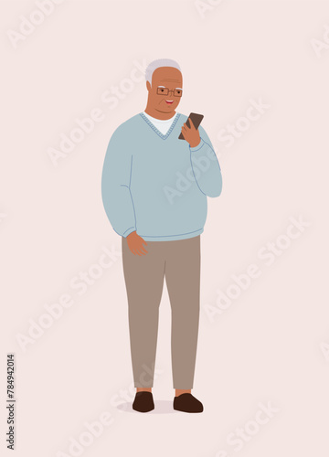 One Smiling Black Elderly Man Using His Mobile Phone While Standing.