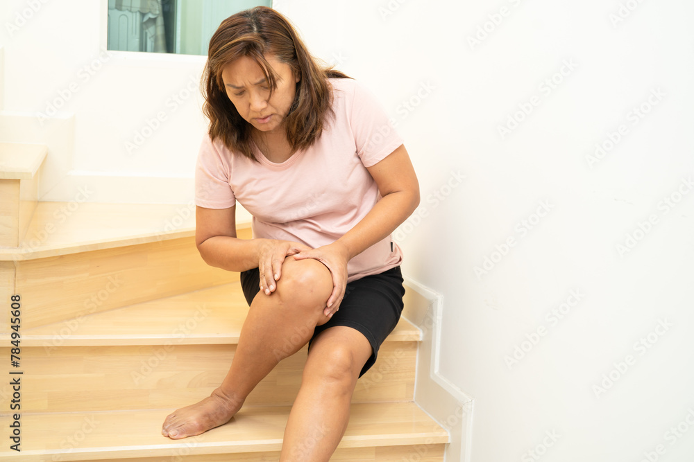 Asian lady fall down the stairs and pain at knee because slippery surfaces. Asian lady fall down the stairs and pain at knee because slippery surfaces.