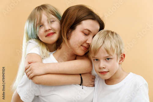 Happy people. Mothers Day and Fathers day . Mother hugging her cute children . Happy loving family. Mother and her children girl and boy playing and hugging. Brother and sister. 