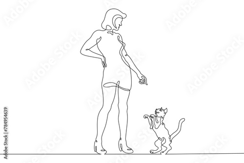 One continuous line.Woman with a cat. Girl plays with a pet. Domestic cat. One continuous line drawn isolated, white background.