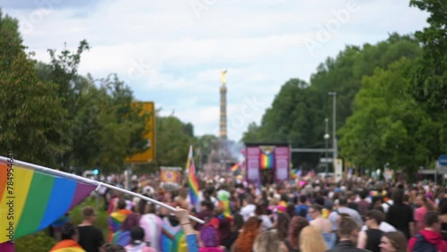 Many people wave rainbow flag. Crowd walk city street. Fun lgbt community symbol. Stop no homophobia concept. Joy pride month fest. Bi gay man go csd love day. Queer culture parade. Hold colorful sign photo