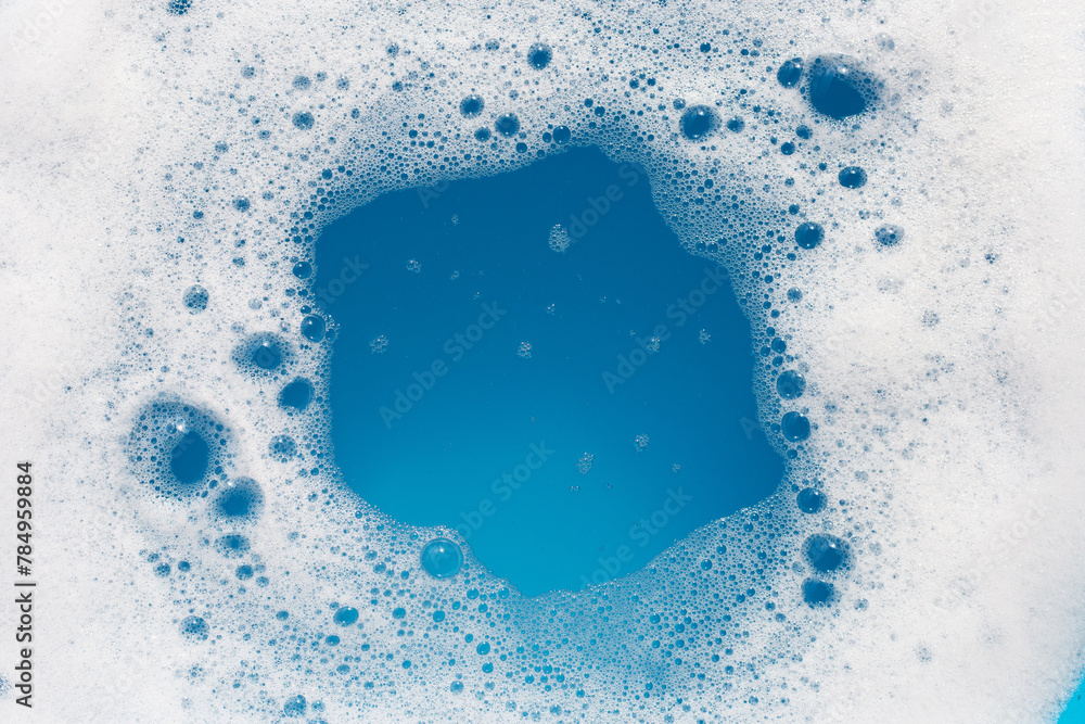 Naklejka premium Detergent foam bubble on wate. Blue background, Soap sud