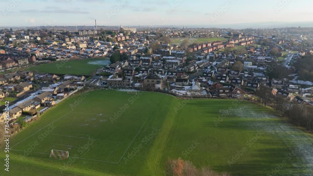 Drone's-eye winter view captures Dewsbury Moore Council estate's typical UK urban council-owned housing development with red-brick terraced homes and the industrial Yorkshire. Working class housing Drone's-eye winter view captures Dewsbury Moore Council estate's typical UK urban council-owned housing development with red-brick terraced homes and the industrial Yorkshire. Working class housing