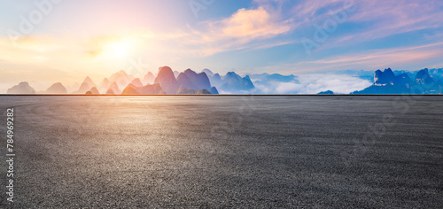 Asphalt road and karst mountain with sky clouds natural landscape at sunrise. Panoramic view. © ABCDstock