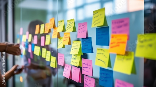 A Selective focus , Creative professionals, co-worker standing and discussing at the office behind glass wall with sticky notes  for a brain storm