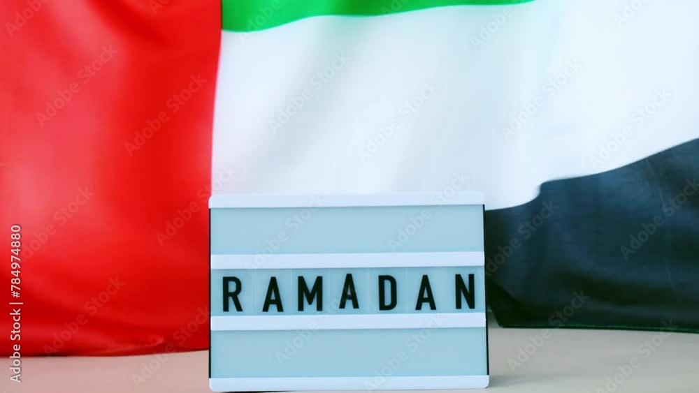 RAMADAN text frame on United Arab Emirates waving flag made from silk ...