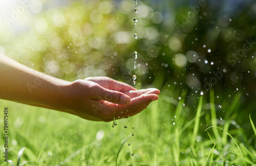 Hands, nature and water drops for eco friendly and sustainable environment on earth day outdoor. Splash in palm with growth and garden for quality, rule or regulation of clean liquid for human rights