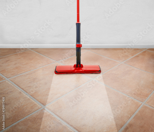 Red Mop on the floor and white wall background