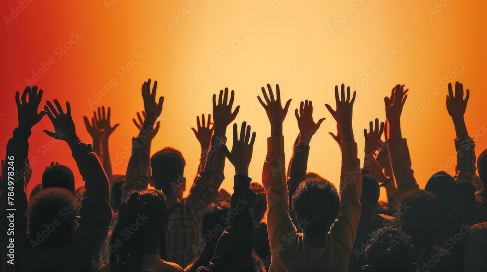 Silhouetted People With Raised Hands Standing Together