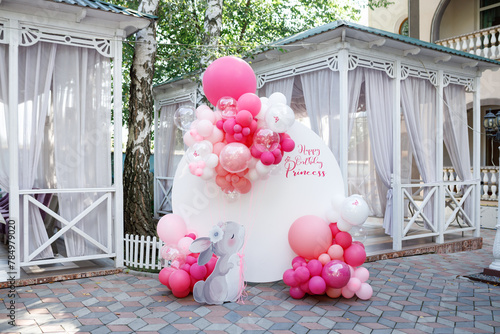 Birthday decorations with pink balloons and a bunny figurine