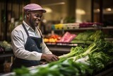 Joyful African-American seller selects vegetables in a vegetable shop for a customer.