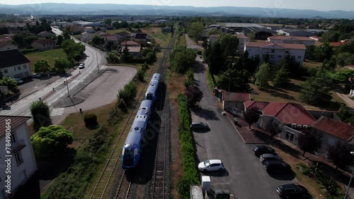 drone shot over a regional train leavig the train station in french countryside, loire department, auvergne rhone alpes region, france photo