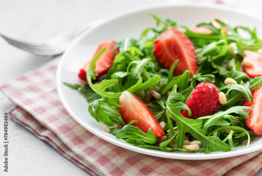 Fresh Strawberry Arugula Salad With Pine Nuts Served on a Bright Day Fresh Strawberry Arugula Salad With Pine Nuts Served on a Bright Day