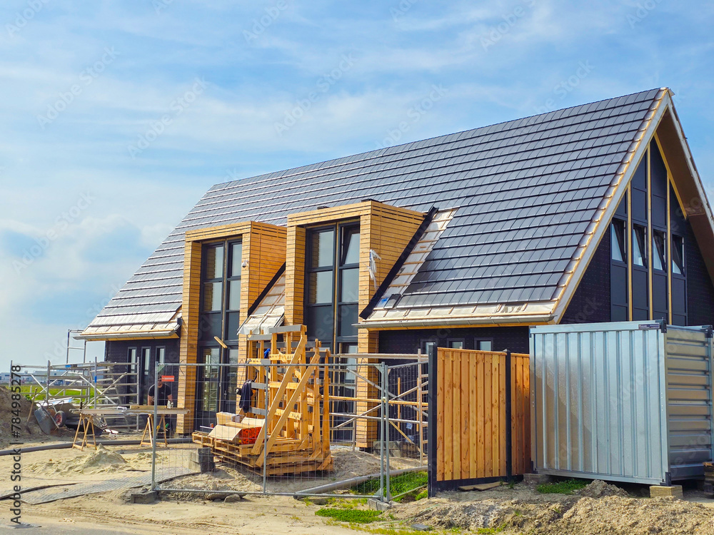Obraz premium construction site of a new Dutch Suburban area with modern family houses, newly built modern family homes in the Netherlands , prefab house