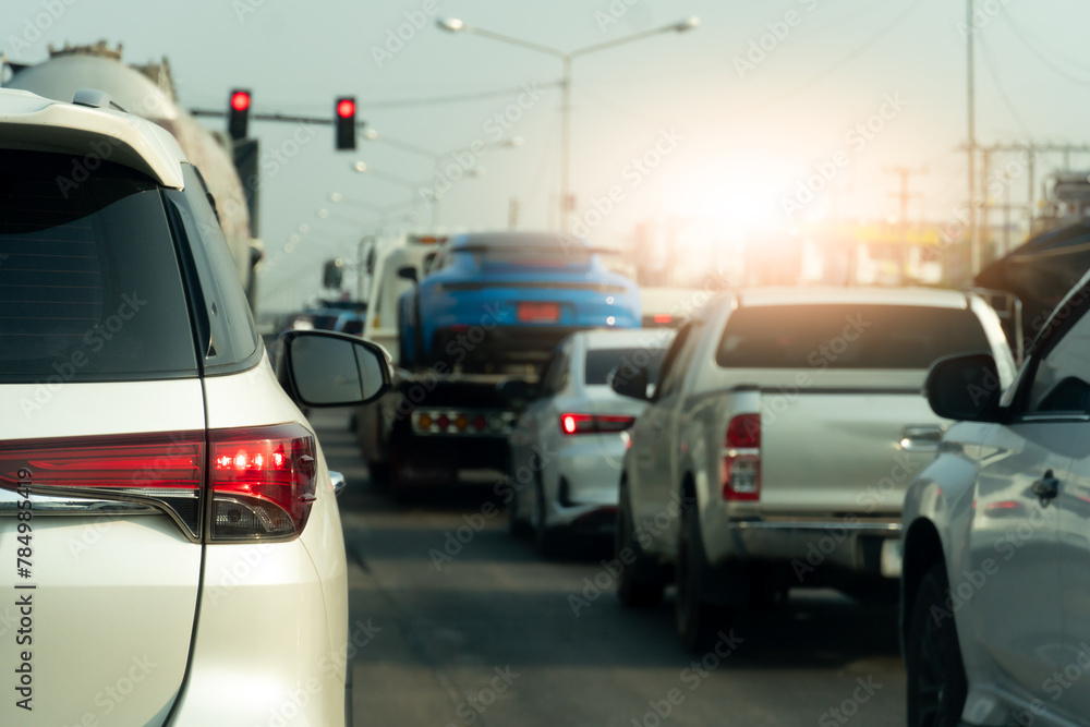 Luxury of white car stop on the asphalt road. Traveling in the provinces during on day. Open light brake in the city. Traffic jam after to work in an urban area.