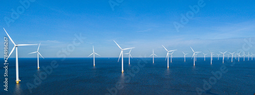 offshore windmill park and a blue sky, windmill park in the ocean. Netherlands Europe. windmill turbines in the Noordoostpolder Flevoland photo