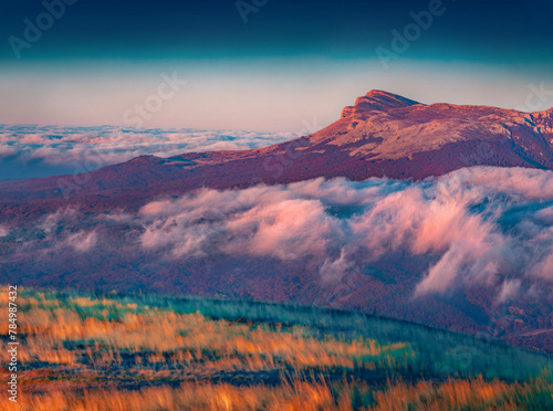 Breathtaking autumn view of Demerdzhi plateau, Crimea, Ukraine, Europe. Foggy morning scene of Crimean Mountains. Beauty of nature concept background.