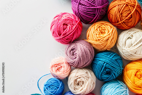 colorful balls of woolen threads on the white background with copy space