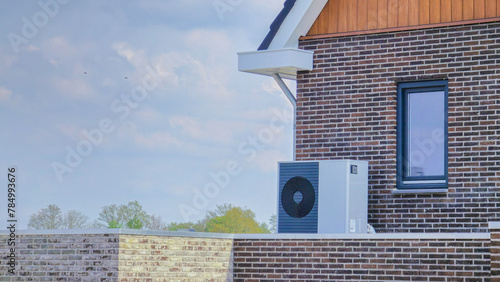 Cuadro en lienzo air source heat pump unit installed outdoors at a modern home with bricks in the