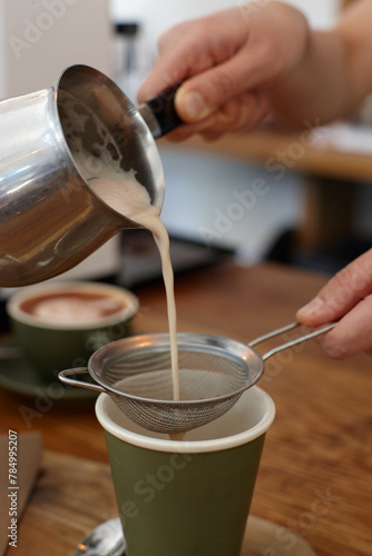 Hot chai latte being prepared by barista