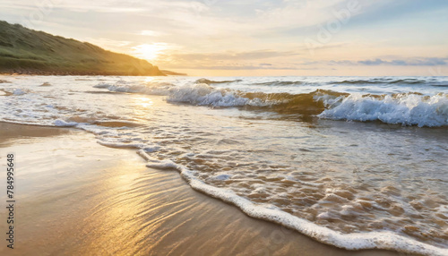 A serene beach at sunset with waves gently lapping the shore and golden sunlight reflecting on the wet sand