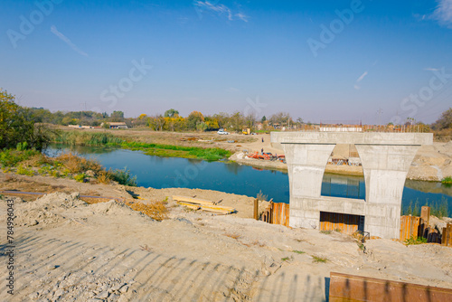 Huge pole in foundation with metal piles, construction of concrete-reinforced bridge pillars at building site