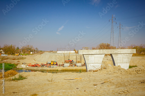 Huge pole in foundation with metal piles, construction of concrete-reinforced bridge pillars at building site