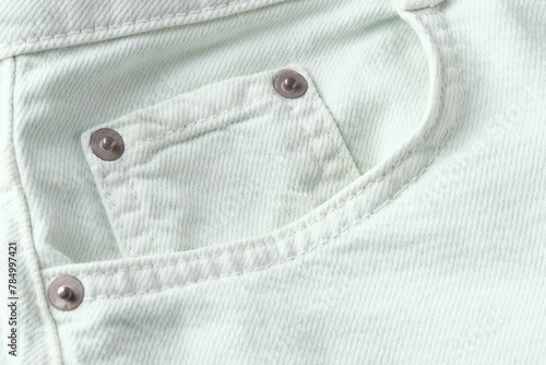 Close up of light mint jeans pocket,pastelt denim cotton fabric texture