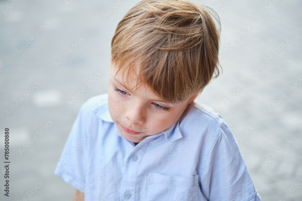 Handsome smiling little boy on the sunny urban background . Close-up portrait. Blond hair, blue eyes , 9 years boy smiling, having fun in the city. High quality photo Handsome smiling little boy on the sunny urban background . Close-up portrait. Blond hair, blue eyes , 9 years boy smiling, having fun in the city. High quality photo