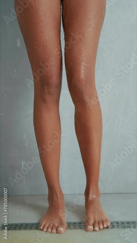  a close-up shot of a woman legs and feet, female posing taking shower 