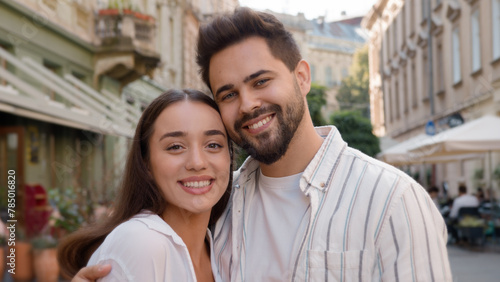 Close up young European Caucasian happy couple woman man together city outside bonding love support closeness sweetheart toothy dental smile harmony feeling honeymoon tenderness girlfriend boyfriend