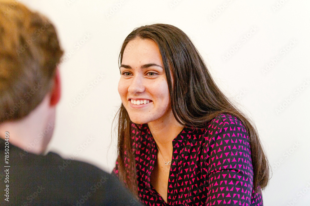 Aboriginal woman sitting in a meeting with a man in an office Aboriginal woman sitting in a meeting with a man in an office