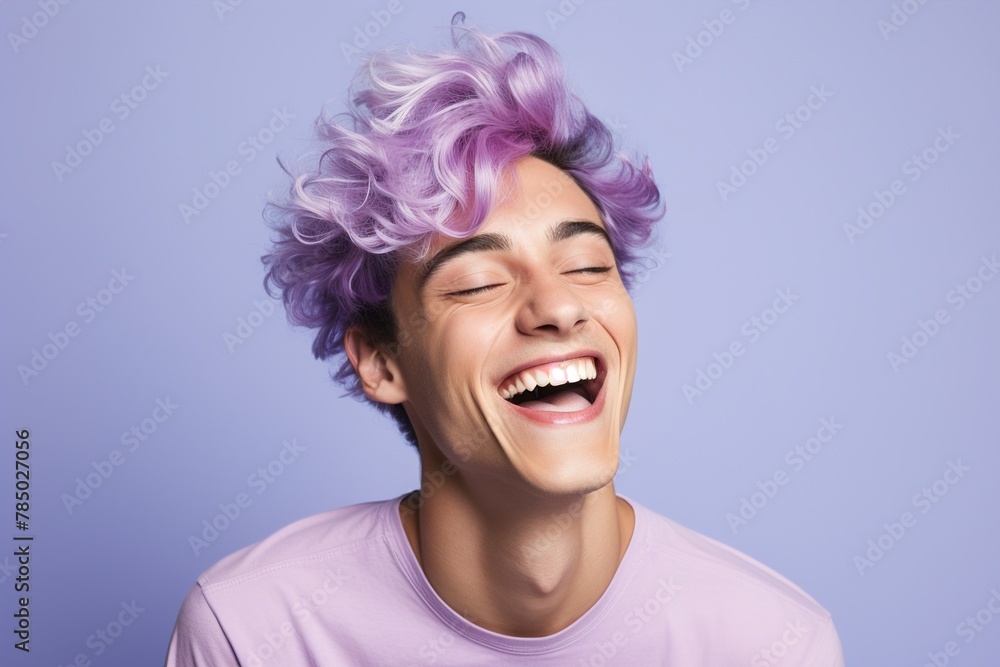 A man with purple hair is smiling and laughing