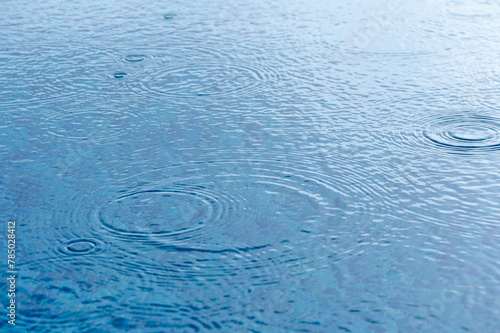 Round droplets of water over circles on pool water. 1