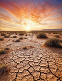Drought land, cracked earth,  arid clay soil in the desert at sunset, Global warming concept. 
